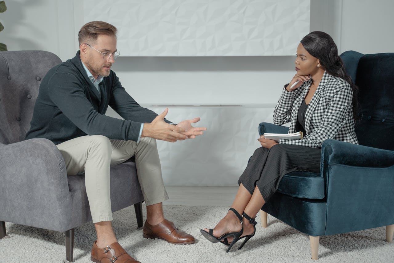 services-04 A business conversation between a man and woman in a modern office setting, focusing on engagement and communication.