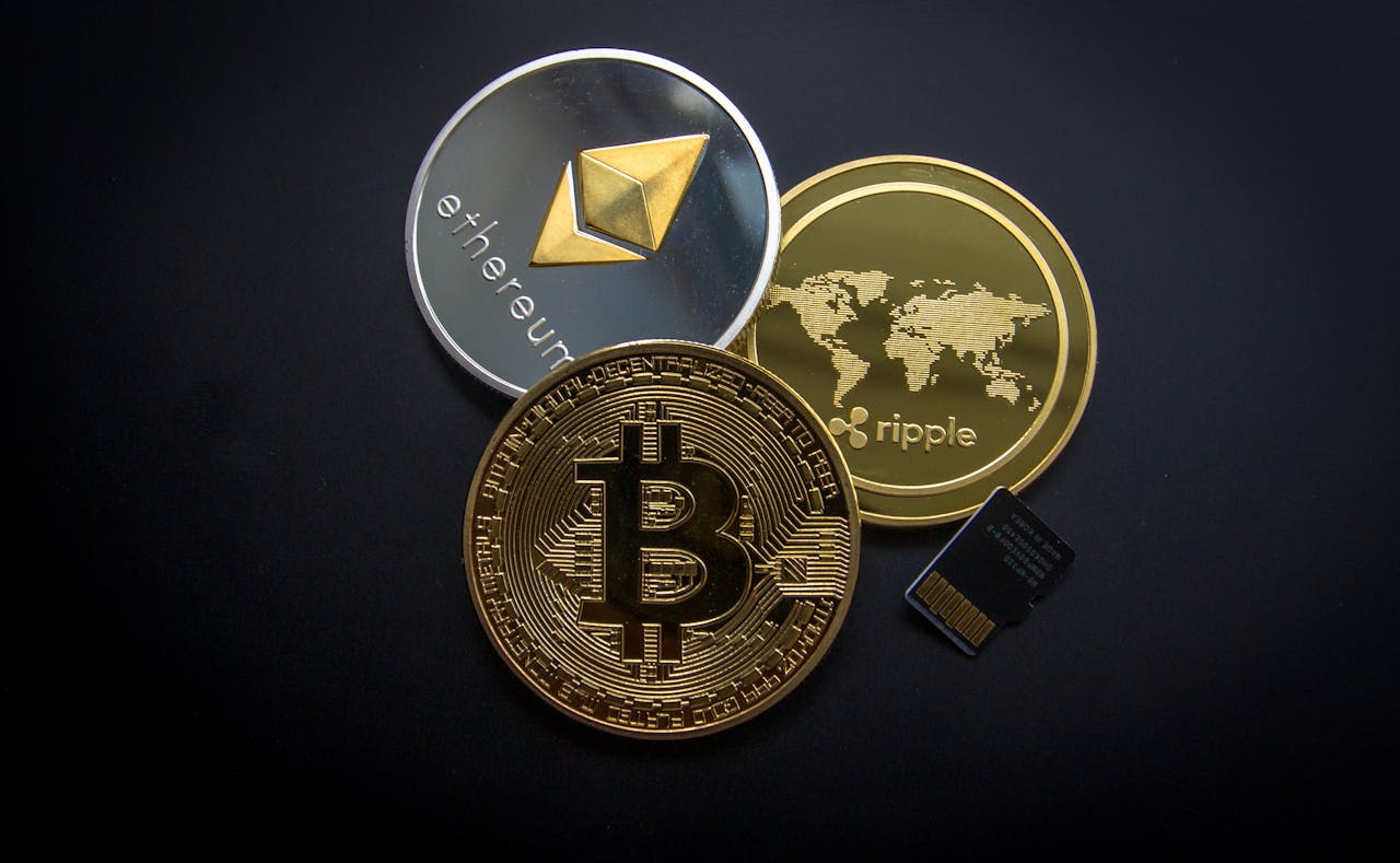 services-03 A striking image of Bitcoin, Ethereum, and Ripple coins illustrating modern digital currency.
